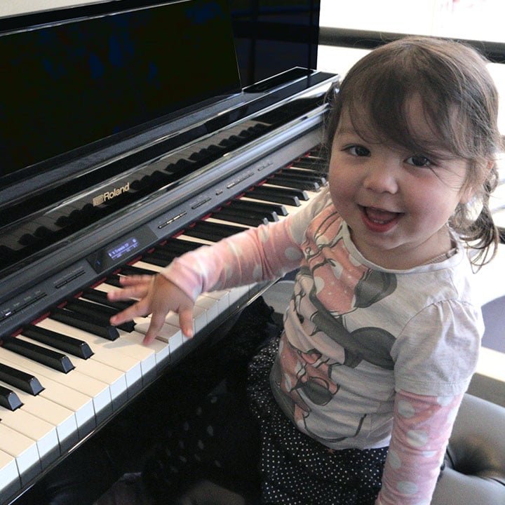 child learning to play the piano