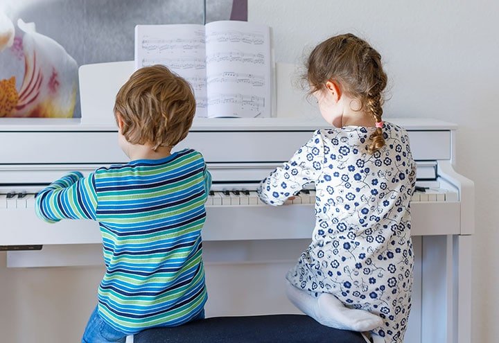 children learn to play piano